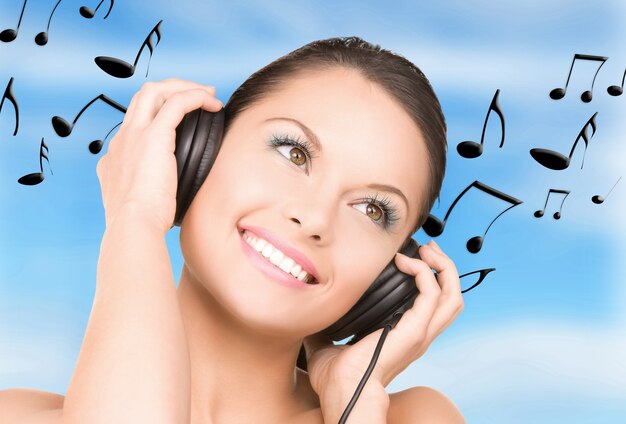 picture of happy woman in headphones over white