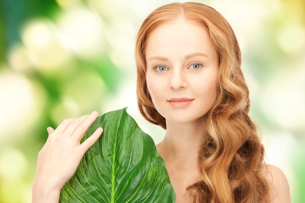 picture of happy woman with green leaf