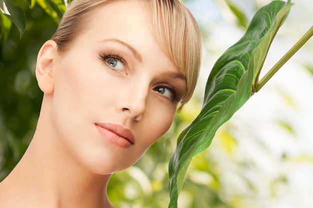 picture of happy woman with green leaf