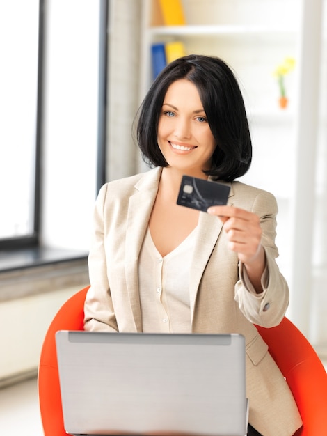 picture of happy woman with laptop computer and credit card