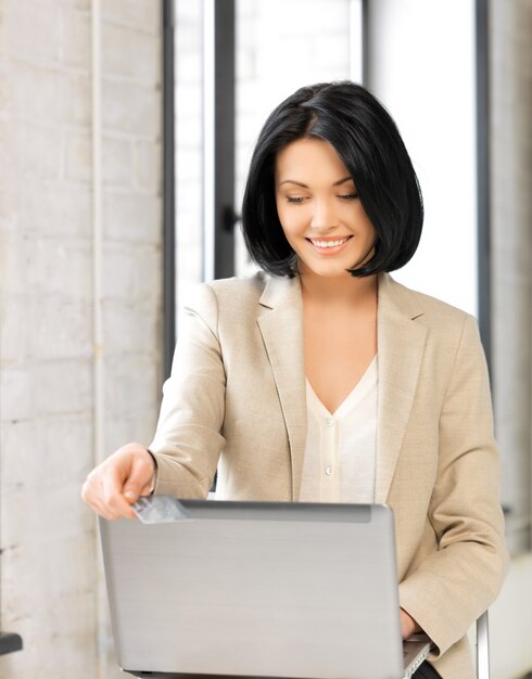 picture of happy woman with laptop computer and credit card.