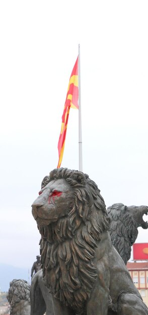 picture of a Lion statue with red paint on eyes