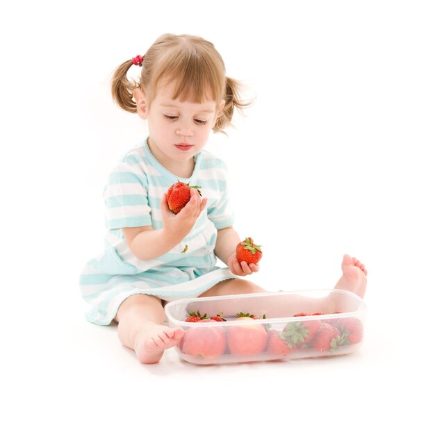 picture of little girl with strawberry over white