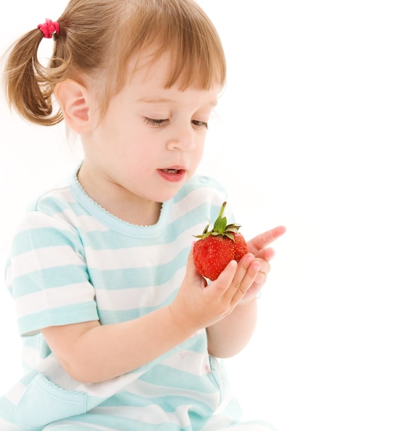 picture of little girl with strawberry over white