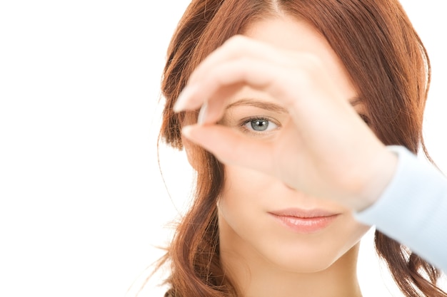 Picture of lovely woman looking through hole from fingers