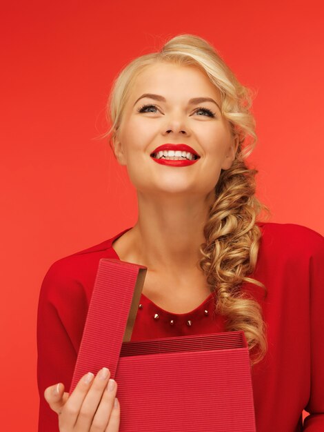 picture of lovely woman in red dress with opened gift box