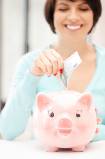 picture of lovely woman with piggy bank and money