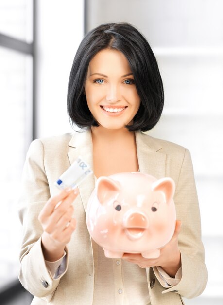 picture of lovely woman with piggy bank and money