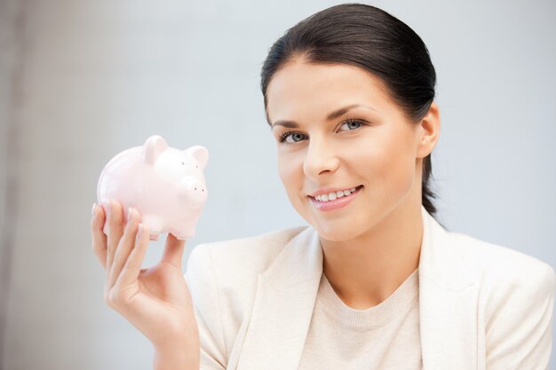 picture of lovely woman with piggy bank