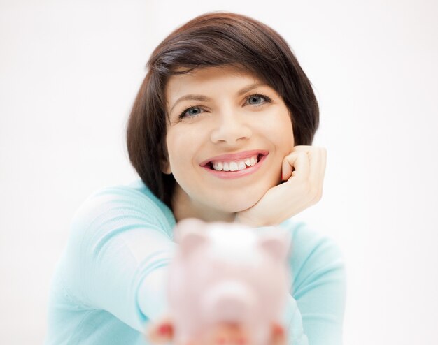 picture of lovely woman with piggy bank