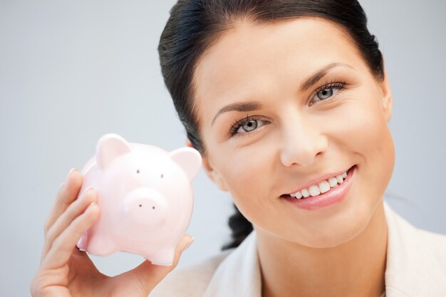 picture of lovely woman with piggy bank