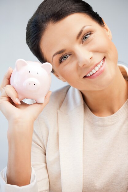 picture of lovely woman with piggy bank