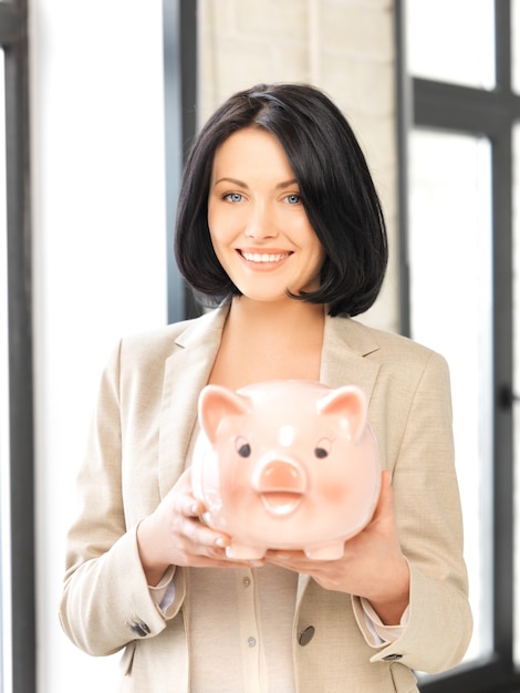 picture of lovely woman with piggy bank