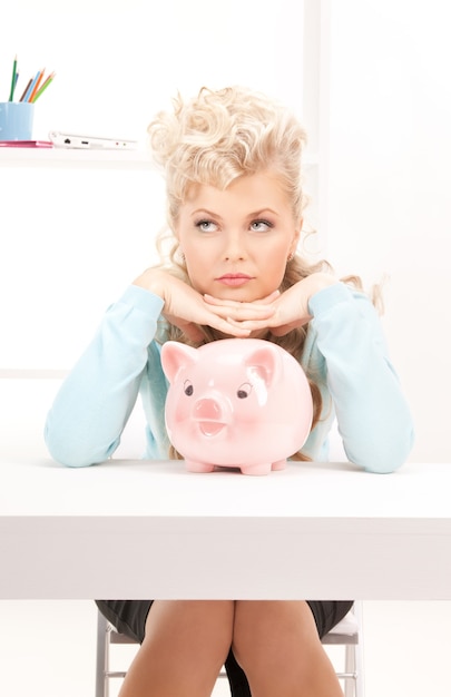 picture of lovely woman with piggy bank