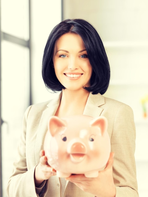 picture of lovely woman with piggy bank