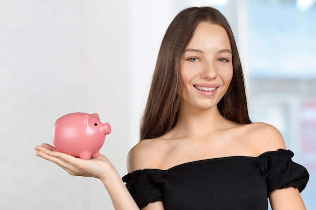 Picture of lovely woman with piggy bank