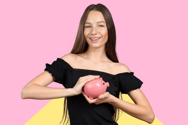 Picture of lovely woman with piggy bank