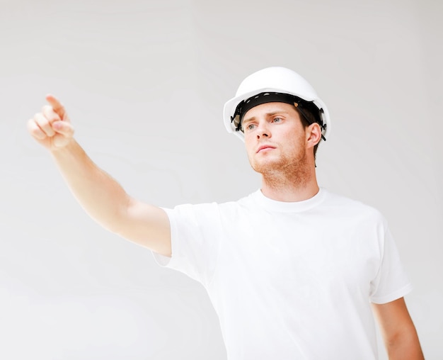 Photo picture of male architect in helmet showing direction