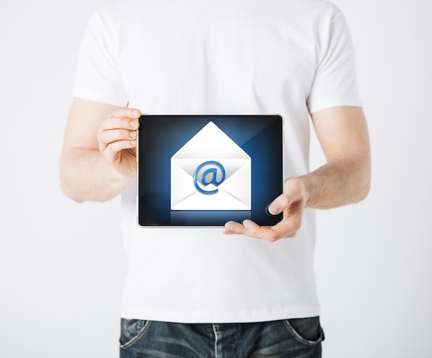 picture of man holding tablet pc with email sign