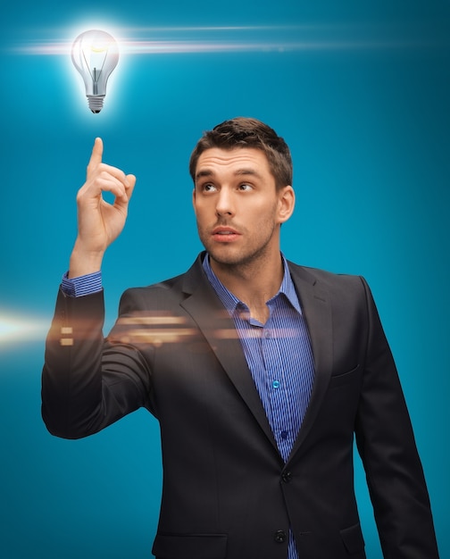 Photo picture of man in suit with light bulb