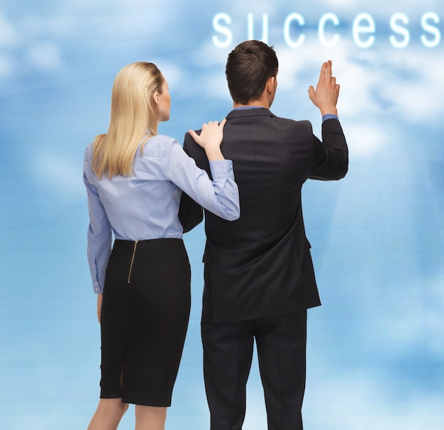 Photo picture of man and woman with success word button in the sky