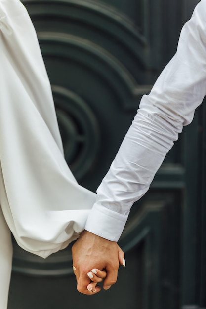 Picture of man and woman with wedding ringYoung married couple holding hands ceremony wedding day Newly wed couple's hands with wedding rings