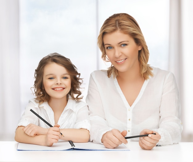 picture of mother and daughter doing home work