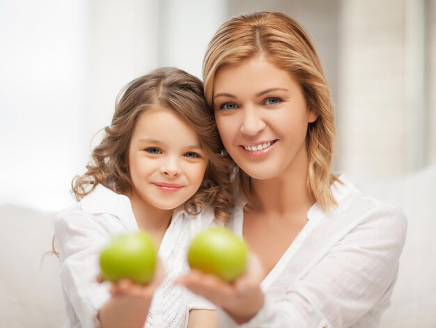 picture of mother and daughter with green apples