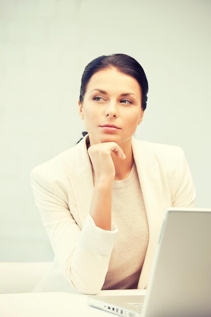 picture of pensive woman with laptop computer