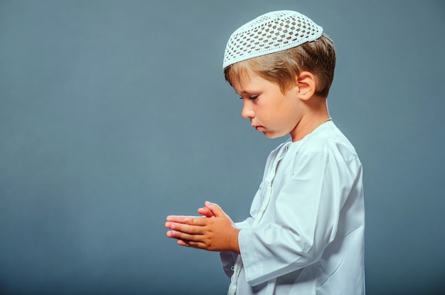 Picture of praying Middle eastern boy.