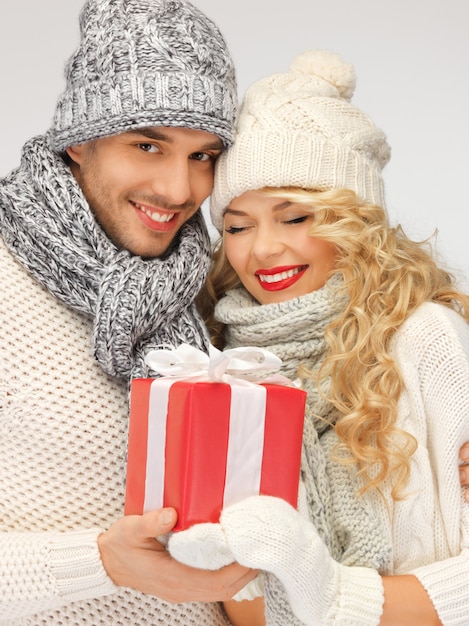 picture of romantic couple in a sweaters with gift box