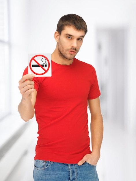 picture of serious man in red shirt with no smoking sign