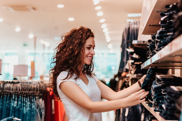 Picture showing happy woman shopping for clothes.