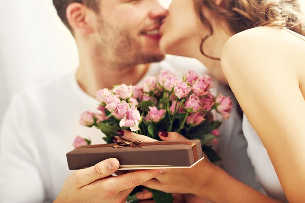 Picture showing man giving present to woman in bed