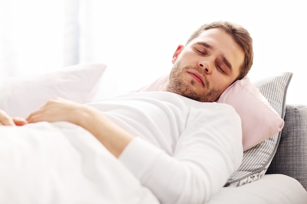 Picture showing young man sleeping in bed