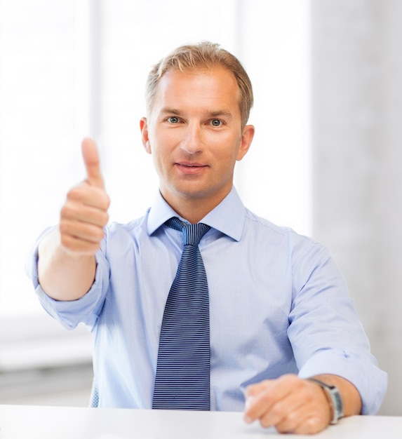 picture of smiling businessman showing thumbs up