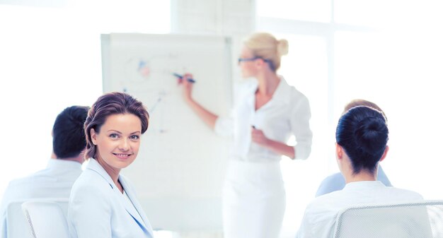 Foto foto di una donna d'affari sorridente durante una riunione di lavoro in ufficio