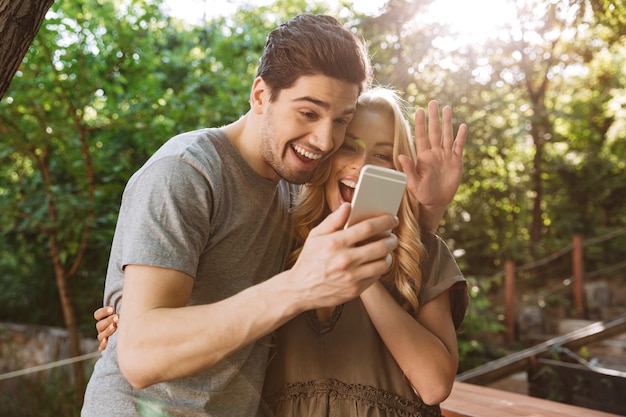 Picture of Smiling lovely couple posing together and making selfie