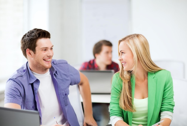 picture of smiling students looking at each other at school