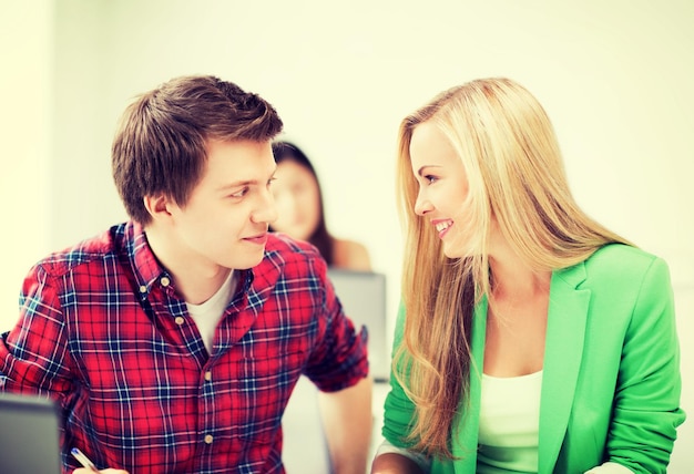 picture of smiling students looking at each other at school