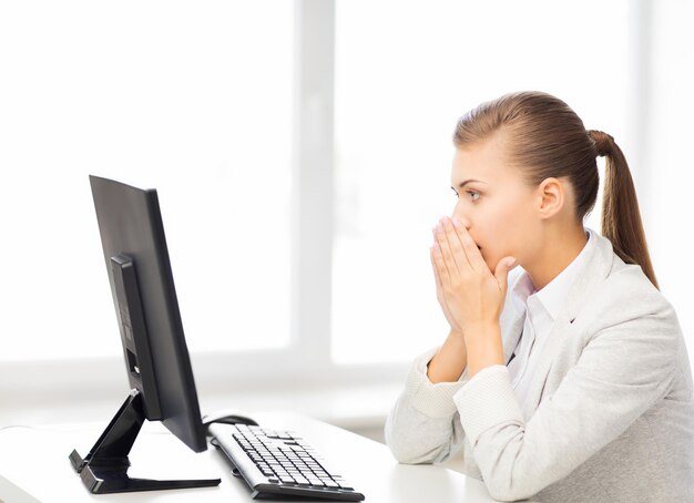 picture of stressed student with computer in office