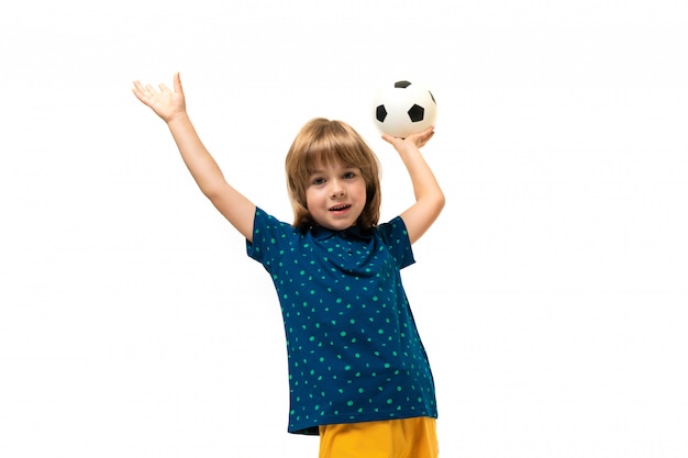 Picture of a teenage caucasian boy holds a soccer ball in one hand isolated on white background