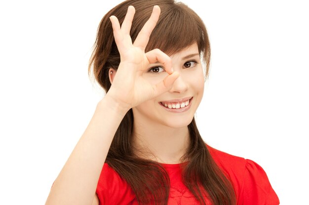 picture of teenage girl looking through hole from fingers