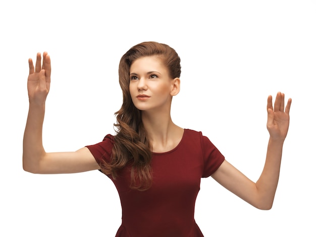 Photo picture of teenage girl in red dress working with something imaginary