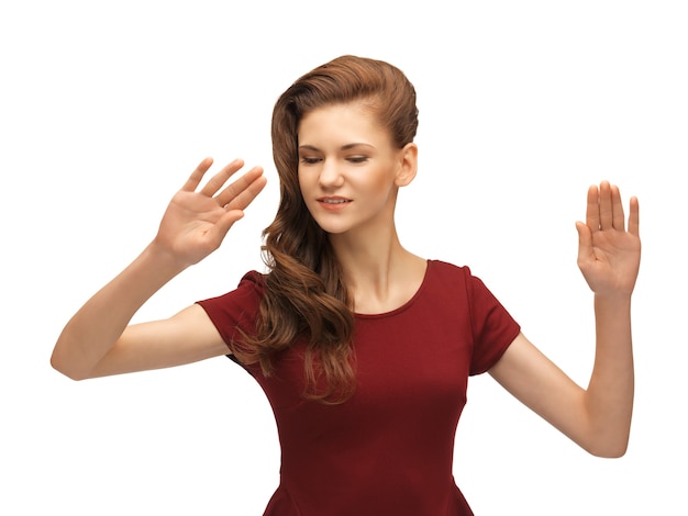 picture of teenage girl in red dress working with something imaginary