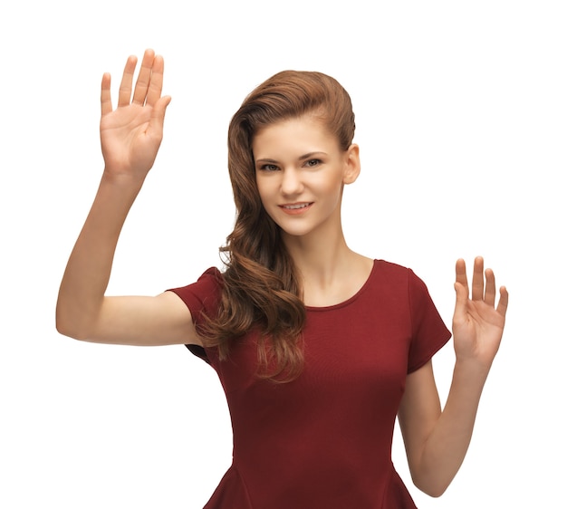 Photo picture of teenage girl in red dress working with something imaginary