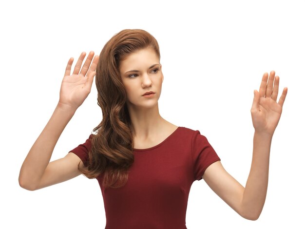 picture of teenage girl in red dress working with something imaginary