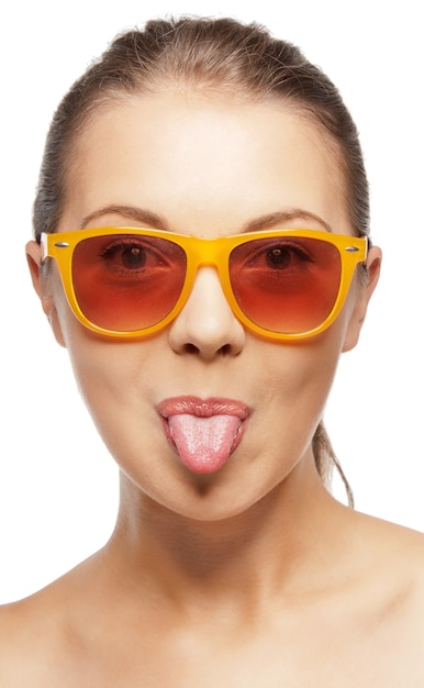 picture of teenage girl in shades sticking out her tongue