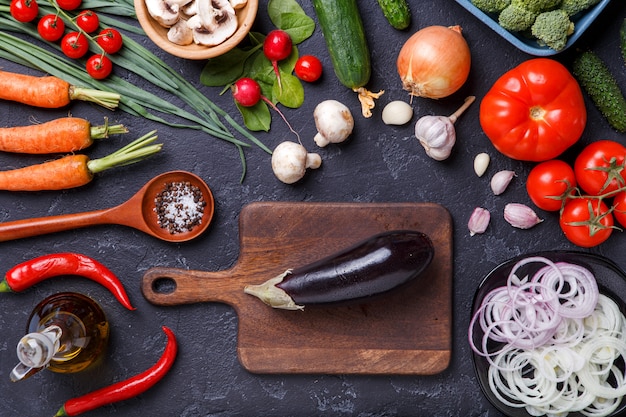 Picture on top of fresh vegetables, champignons, cutting board, butter, knife, eggplant