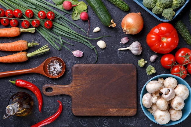 Picture on top of fresh vegetables, champignons, cutting board, butter
